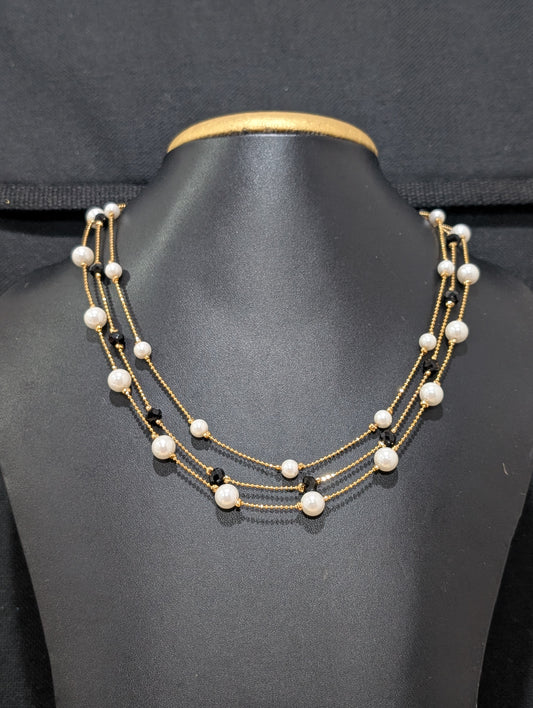 Triple stranded pearl and black bead necklace