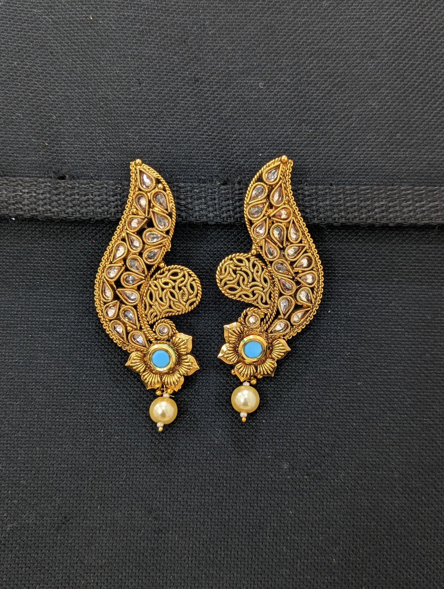 Curvy design polki stone pasted gold plated earrings - Simpliful