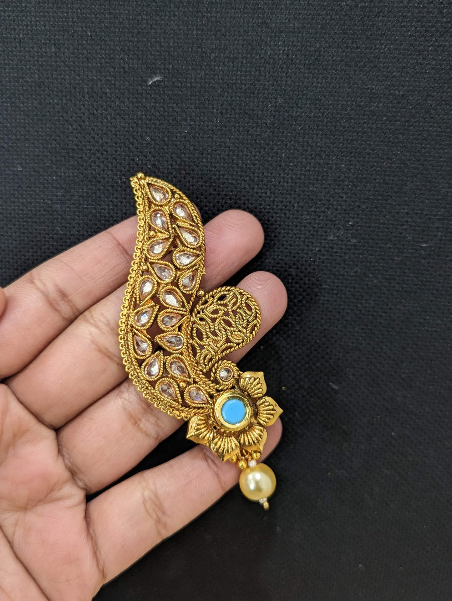 Curvy design polki stone pasted gold plated earrings - Simpliful