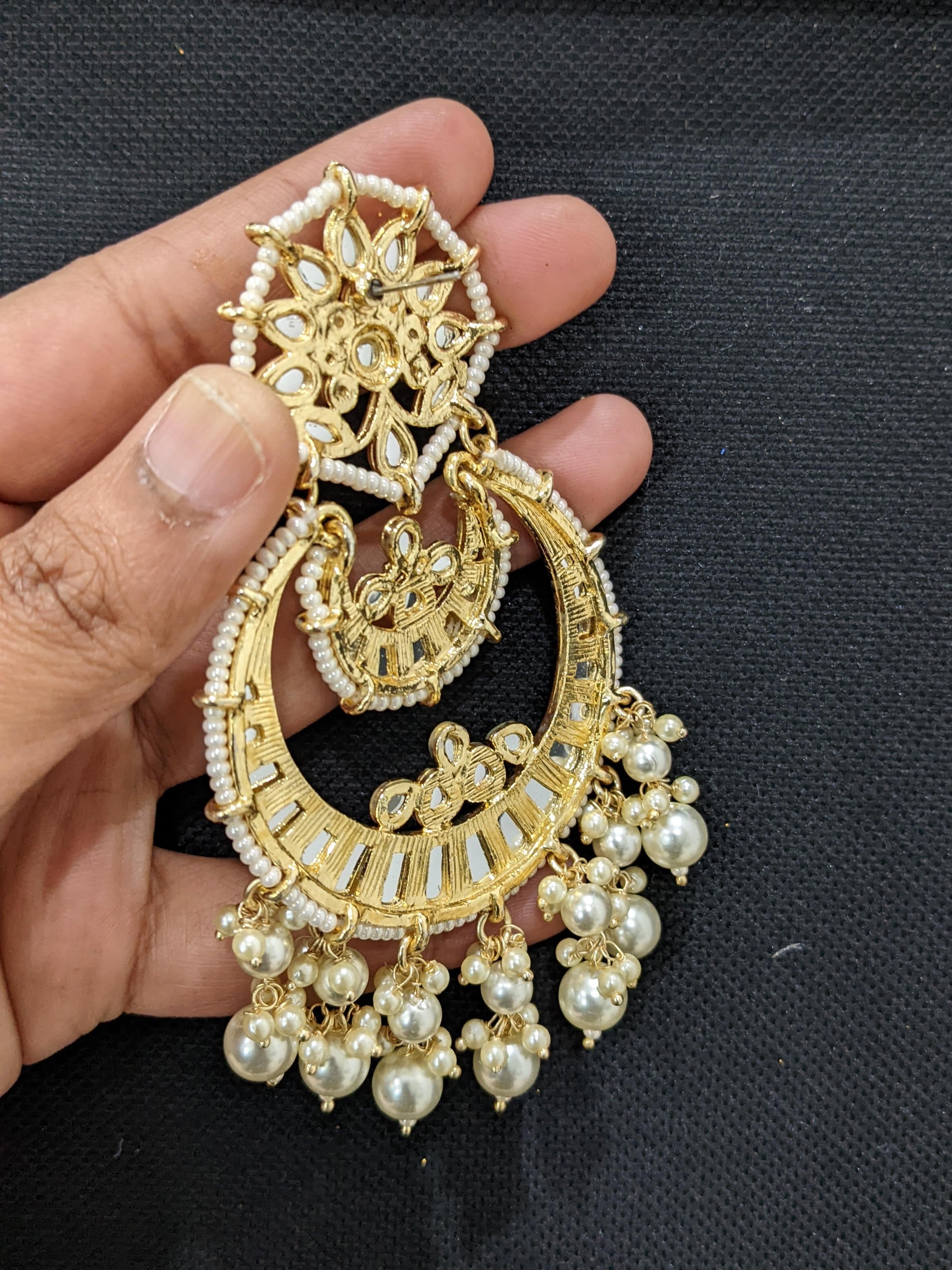 This fancy design kundan maang tikka with earrings set is crafted with –  Look Ethnic